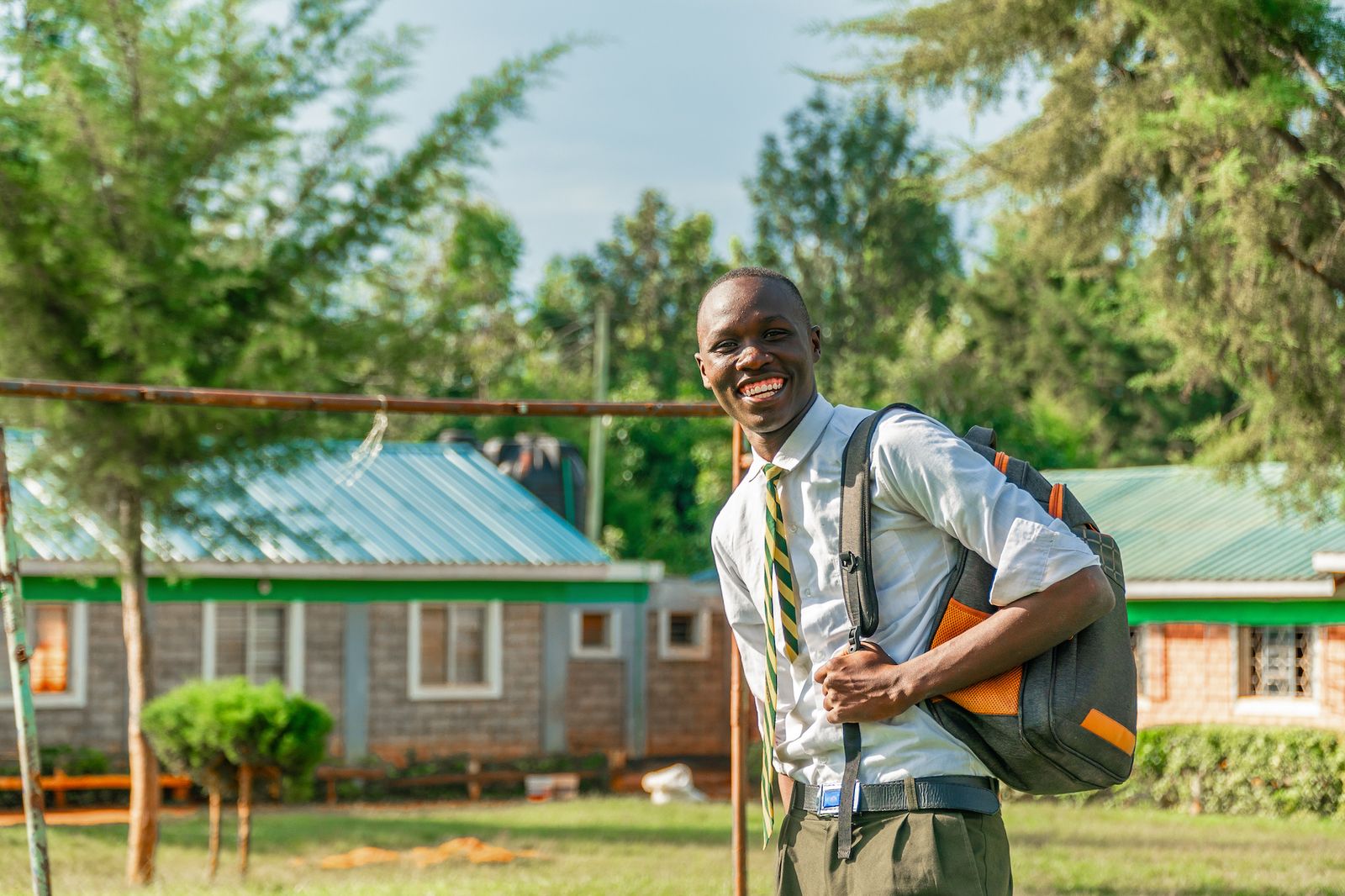 A student smiling outside the Milele campus in Kenya
