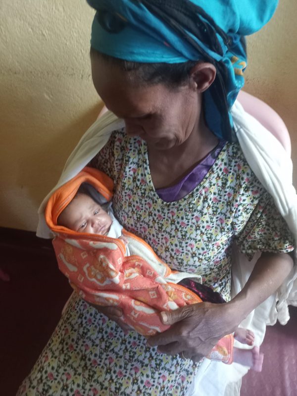 A caregiver holding a rescued newborn at Talita Rise Up in Ethiopia
