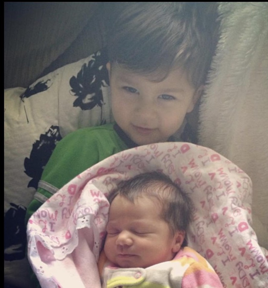 Levi holding his newborn sister Savannah